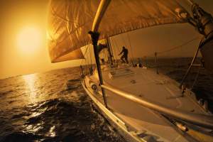 people on a sail boat at the sunset